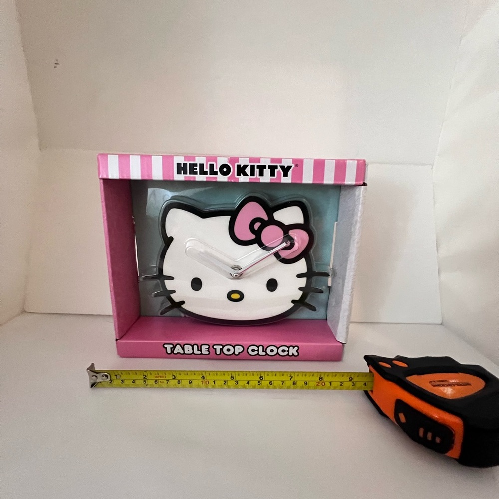 Hello Kitty table top clock with a white and pink design #HelloKitty